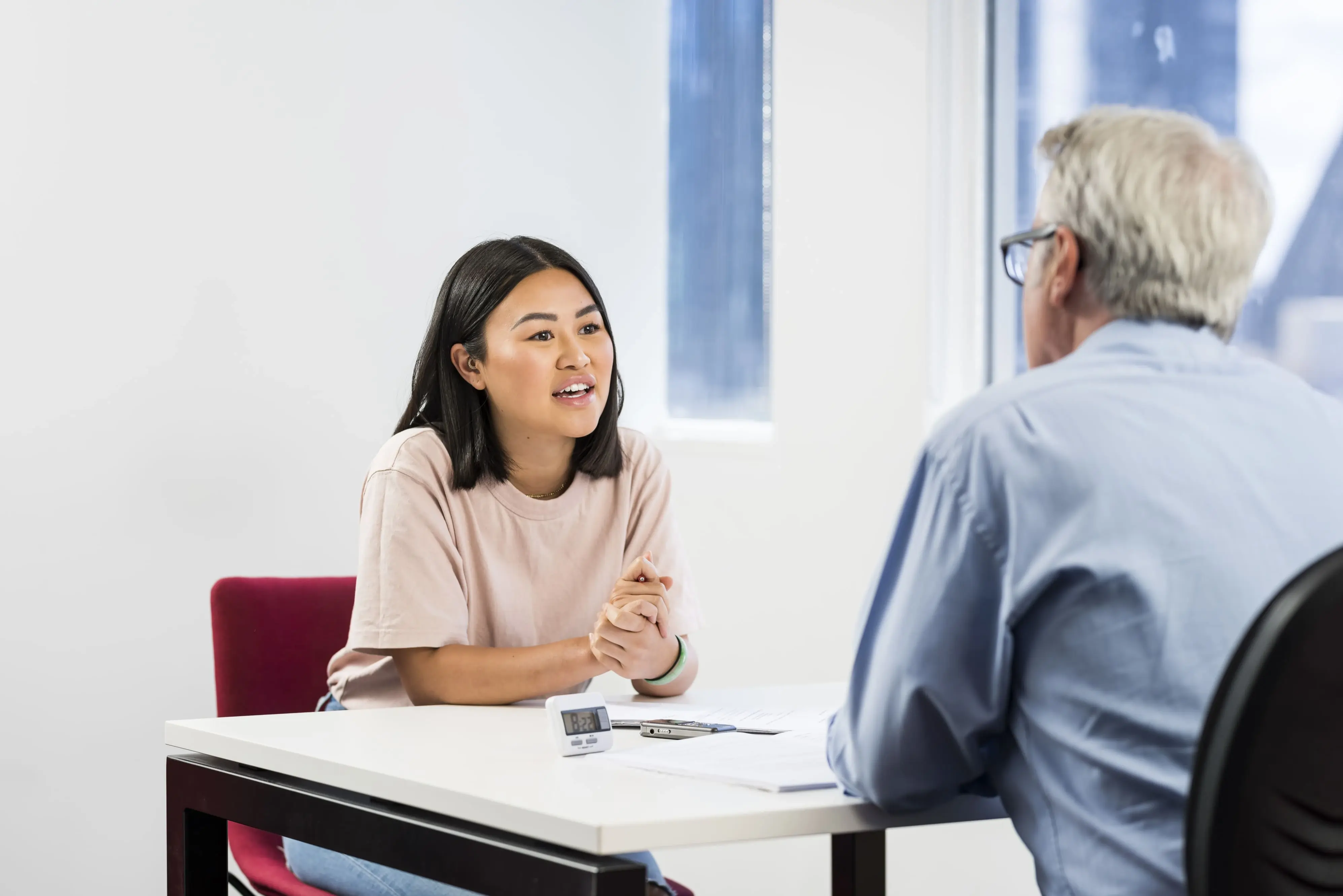 Woman speaking to an examiner